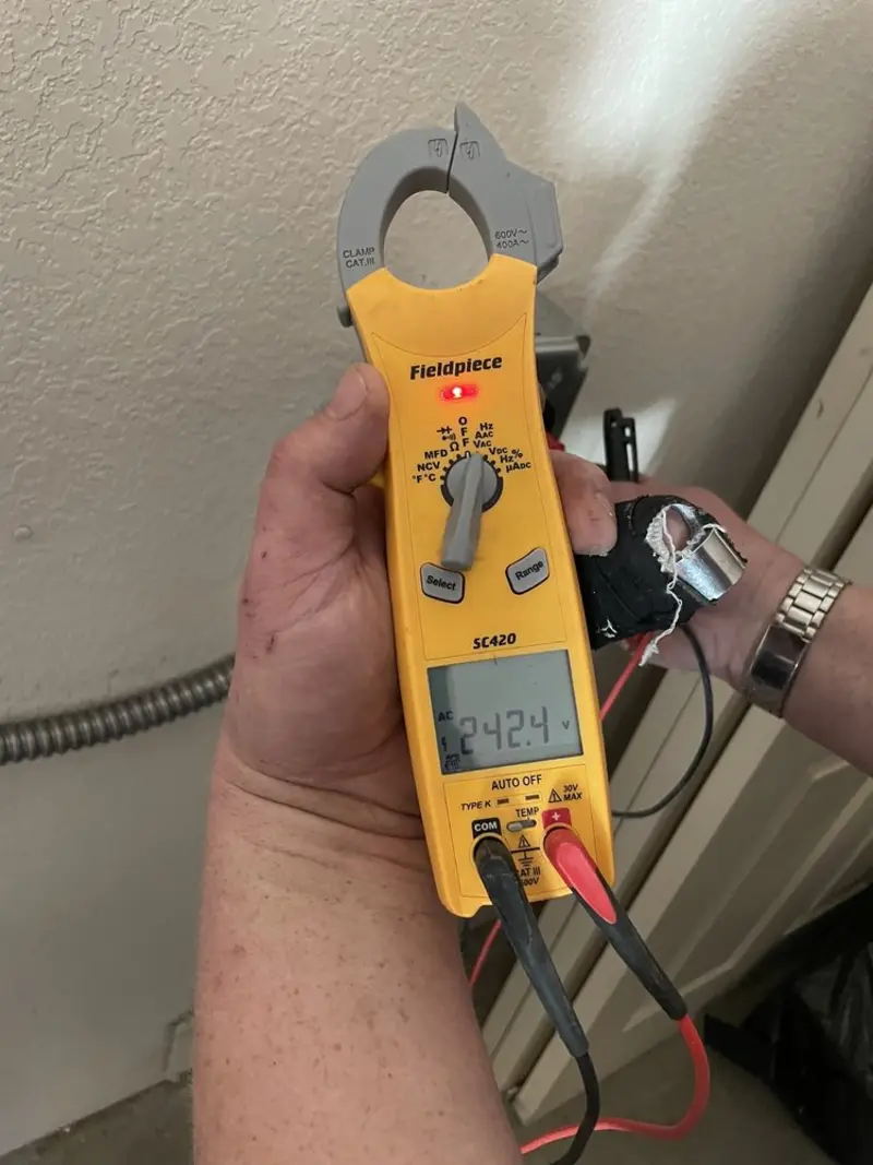 Voltage testing with clamp meter during Recessed Lighting Installation in Avon